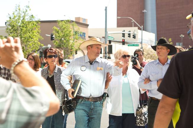 Ammon Bundy, along with family members and supporters, prepare to speak with the media during a peaceful protest in front of the Metro Police department, Friday May 2, 2014.