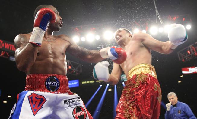 J'Leon Love, left, of the U.S. connects on Marco Antonio Periban of Mexico during their super middleweight fight at the MGM Grand Garden Arena on Saturday, May 3, 2014.