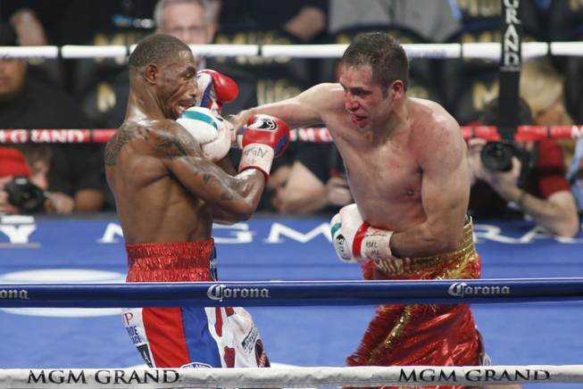 J'Leon Love, left, of the U.S. takes a punch from Marco Antonio Periban of Mexico during their super middleweight fight at the MGM Grand Garden Arena on Saturday, May 3, 2014.