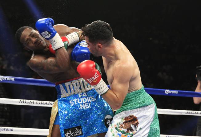 Adrien Broner of the U.S. takes a hit from Carlos Molina, also of the U.S., during their super lightweight fight at the MGM Grand Garden Arena on Saturday, May 3, 2014.