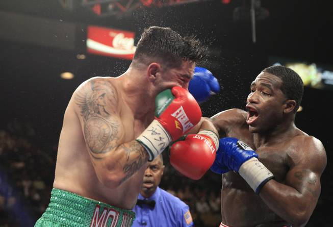 Carlos Molina of the U.S. takes a punch from Adrien Broner, also of the U.S., during their super lightweight fight at the MGM Grand Garden Arena on Saturday, May 3, 2014.