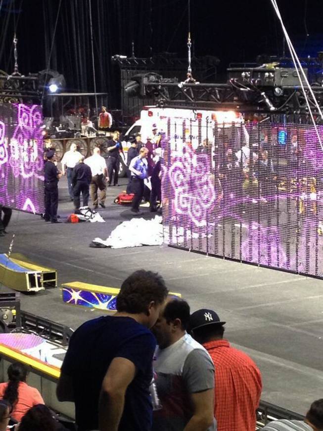 In a cellphone photo provided by Tara Griggs, emergency workers tend to injured performers after a platform collapsed, Sunday, May 4, 2014, during the Ringling Brothers and Barnum & Bailey Circus' Legends show at the Dunkin' Donuts Center in Providence, R.I. At least nine people were injured in the fall, including a dancer below. Roman Garcia, general manager of the show, said the accident occurred during the "hair hang" act in which the performers hang from their hair.