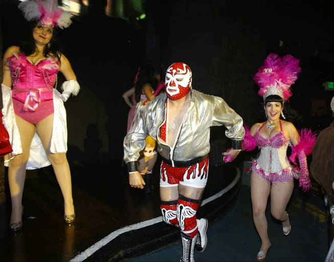 In this Feb. 12, 2014 photo, wrestler Dr. Maldad and Mexican Spitfire of Burlesque, Ruby Champagne, perform at the Lucha VaVoom Valentine’s show of Lucha Libre Mexican wrestling and Burlesque at the Mayan Theatre in downtown Los Angeles.