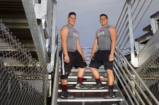 Las Vegas High offensive linemen Mark Gil Gacutan, left, and Mark Anthony Gacutan pose at Las Vegas High School on Monday, May 5, 2014.