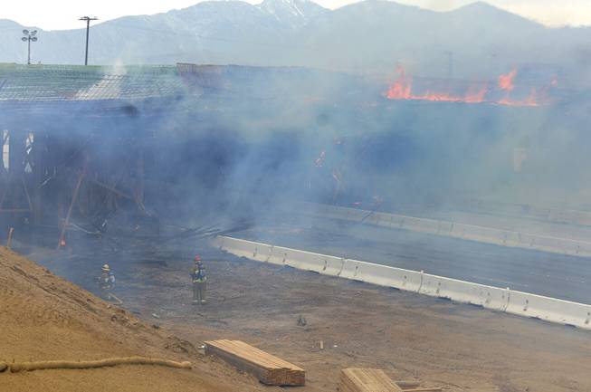 The construction site at Interstate 15 was engulfed in flames on Monday, May 5, 2014, in Hesperia, Calif. The California Highway Patrol's Carlos Juarez says the bridge at Ranchero Road caught fire at about 1:30 p.m. and Interstate 15 was closed soon after because of falling debris.
