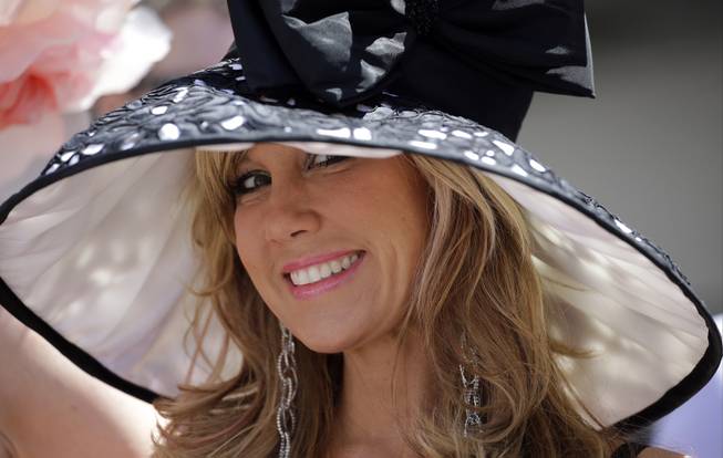Hope Lach of Orlando, Fla., smiles before the 140th running of the Kentucky Derby horse race at Churchill Downs Saturday, May 3, 2014, in Louisville, Ky.