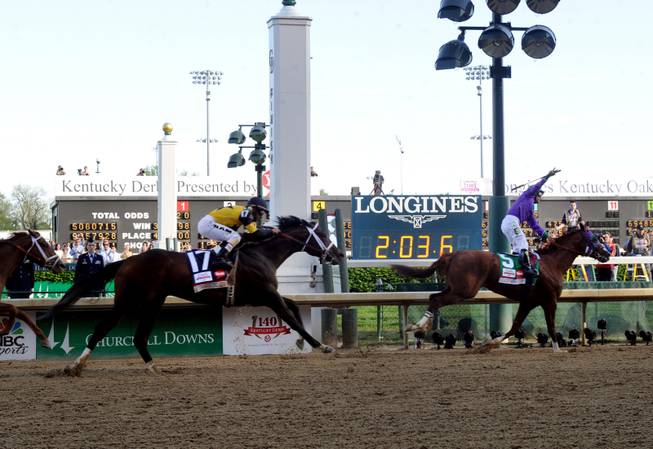 IMAGE DISTRIBUTED FOR LONGINES - California Chrome, ridden by jockey Victor Espinoza, celebrates as he wins the 140th Kentucky Derby, Saturday, May 3, 2014, in Louisville, Ky. Longines, the Swiss watchmaker known for its famous timepieces, is the Official Watch and Timekeeper of the 140th annual Kentucky Derby. (Photo by Diane Bondareff/Invision for Longines/AP Images)