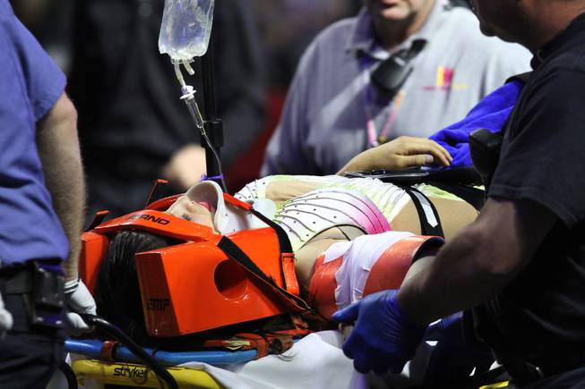 An injured female performer is lifted onto a stretcher after a platform collapsed during an aerial hair-hanging stunt at the Ringling Brothers and Barnum and Bailey Circus, Sunday, May 4, 2014, in Providence, R.I. At least nine performers were seriously injured in the fall, including a dancer below, while an unknown number of others suffered minor injuries. 