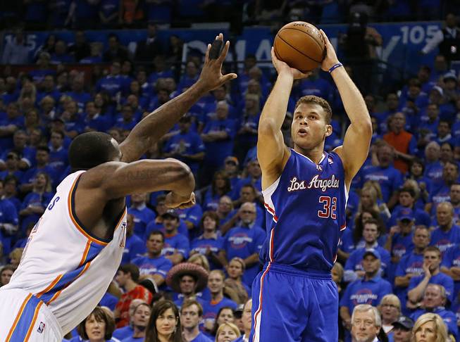Los Angeles Clippers forward Blake Griffin, right, shoots over Oklahoma City Thunder center Kendrick Perkins, left, in the first quarter of Game 1 of the Western Conference semifinal NBA basketball playoff series in Oklahoma City, Monday, May 5, 2014. 