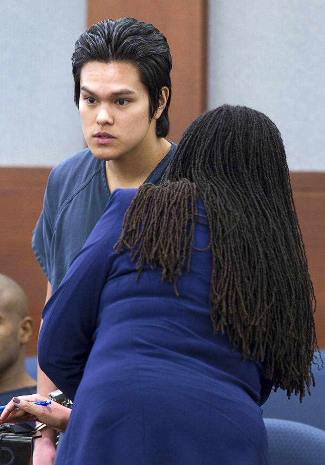 Jeremy Espiritu, 22, listens to defense attorney Donishia Campbell during sentencing at the Regional Justice Center Tuesday, May 6, 2014. Espiritu told police that he stabbed the family dog, Serenity, with a six-inch serrated knife because he "wanted to." The dog later died of the injury. 