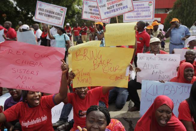 Women attend a demonstration calling on the government to rescue kidnapped schoolgirls of Chibok  secondary school  outside the defense  headquarters, in Abuja,  Nigeria Tuesday, May 6 2014. 