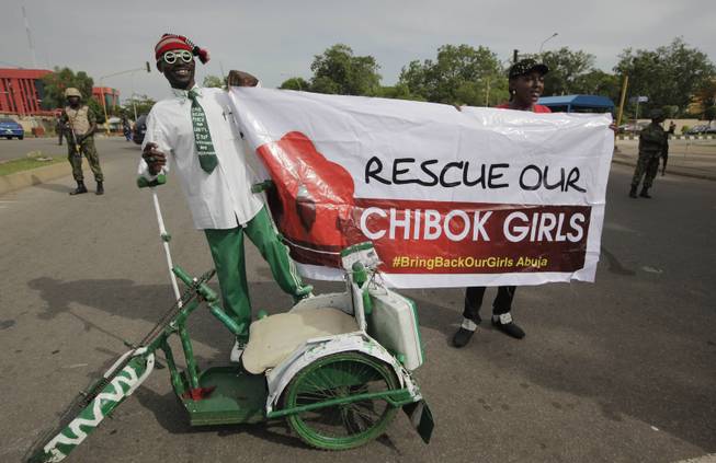 A man attends a demonstration calling on the government to rescue the kidnapped school girls of a government secondary school Chibok, outside the defense headquarters in Abuja, Nigeria, Tuesday May 6, 2014. 