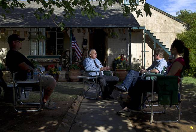 Rancher Cliven Bundy, center, responds to a question during an interview at his ranch house near Bunkerville, Sunday, May 4, 2014. Booda (no last name provided) of Prescott, Ariz. listens at left. 