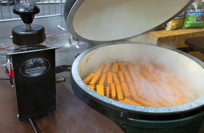 A Smokehouse Chief is used to smoke cheddar cheese in a Big Green Egg grill during the National Hardware Show 2014 outside the Las Vegas Convention Center on Wednesday, May 7, 2014.   L.E. Baskow