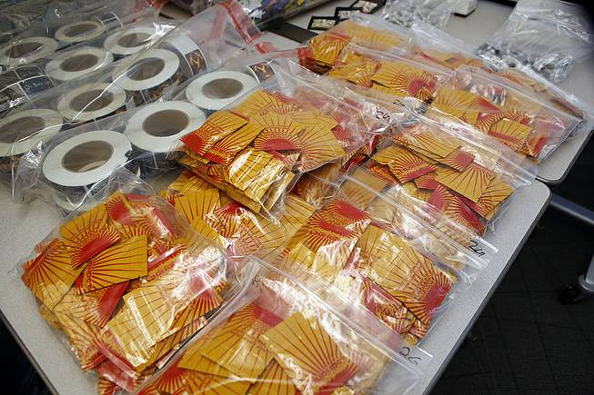 Confiscated synthetic drugs are on display at a news conference at the DEA offices in Centennial, Colo., on Wednesday, May 7, 2014, when it was announced that a federal grand jury in Denver has returned indictments charging nine individuals with conspiracy and drug distribution charges related to "Spice."