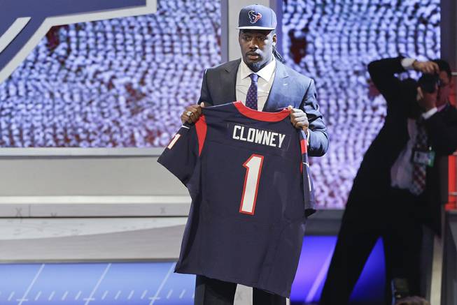 South Carolina defensive end Jadeveon Clowney holds up a jersey for the Houston Texans after being chosen as the first pick in the first round of the 2014 NFL Draft, Thursday, May 8, 2014, in New York. 