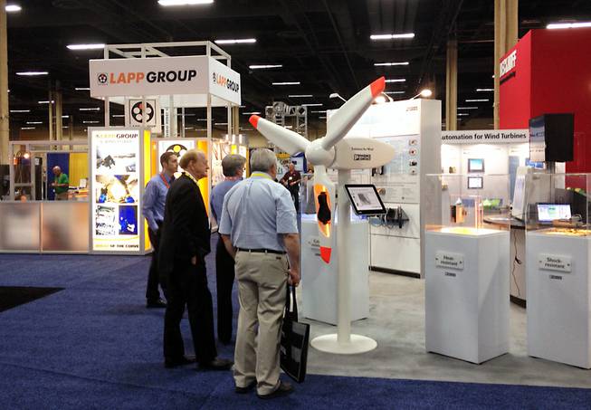 Attendees of the 2014 Windpower Convention at the Mandalay Bay Convention Center take a look at a model wind turbine on the expo floor. This is the first time the American Wind Energy Association, an industry trade group with 1,200 members, has held its annual conference in Las Vegas.