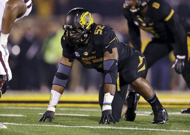 In this Nov. 20, 2013, file photo, Missouri defensive lineman Michael Sam takes up his position during the first half of an NCAA college football game against Texas A&M in Columbia, Mo. Sam was selected in the seventh round, 249th overall, by the St. Louis Rams in the NFL draft Saturday, May 10, 2014. 