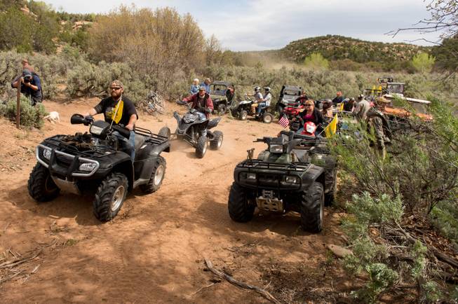 ATV riders cross into a restricted area of Recapture Canyon, north of Blanding, Utah, on Saturday, May 10, 2014, in a protest against what demonstrators call the federal government's overreaching control of public lands. The area has been closed to motorized use since 2007 when an illegal trail was found that cuts through Ancestral Puebloan ruins. The canyon is open to hikers and horseback riders.