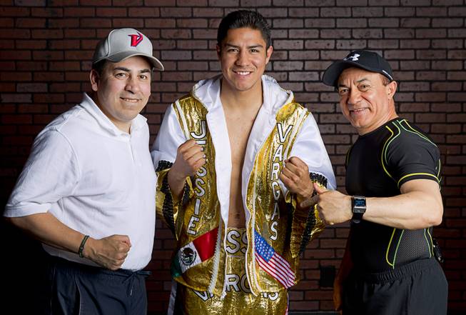 Las Vegan Jessie Vargas poses with assistant trainer Richie Sandoval and trainer Ismael Salas of Cuba before a workout at Top Rank Gym Monday, May 12, 2014. Vargas defeated Khabib Allakhverdiev of Russia at the MGM Grand Garden Arena on April 12 to take the WBA super lightweight (140 lbs.) title. Allakhverdiev was previously undefeated.