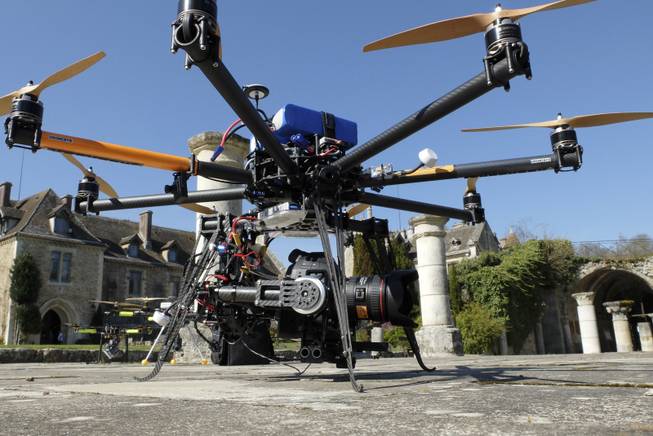 A drone is displayed at the Abbaye Des-Vaux-de-Cernay southwest of Paris, Thursday March 20, 2014. Fornier operated the remote controlled drone used to used to transmit live video of snowboard and ski jump competitions at the Sochi Olympic Games. 