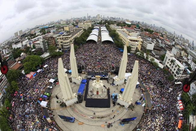 In this photo released by Siam 360 and taken from a drone, anti-government protesters stage a rally, calling for Thai Prime Minister Yingluck Shinawatra to step down, at Democracy Monument in Bangkok, Thailand, Sunday, Nov. 24, 2013. 
