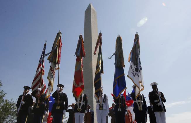 The Armed Forces Color Guard presents the colors at the Washington Monument in Washington, Monday, May 12, 2014, during a ceremony to celebrate its re-opening. The monument, which sustained damage from an earthquake in August 2011, reopened to the public today. 