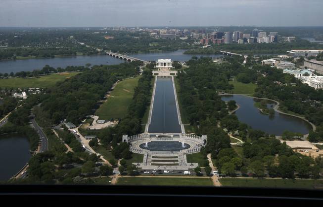 The Lincoln Memorial, rear, and the National World War II Memorial are seen from the 500-foot level of the Washington Monument in Washington, Monday, May 12, 2014, after a ceremony celebrated its re-opening. The monument, which sustained damage from an earthquake in August 2011, reopened to the public today.