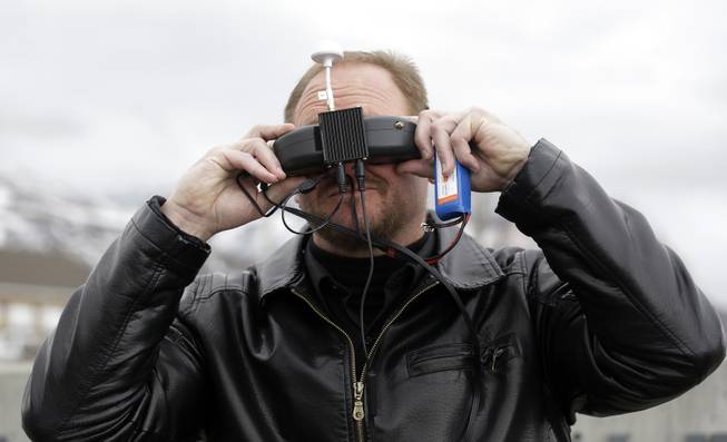 In this Feb. 13, 2014, photo, Deputy Larry Blanchard with the Box Elder County Sheriffs Office search and rescue team, is shown wearing a head set for viewing the video feed from the search and rescue drone during a demonstration Thursday, in Brigham City, Utah. 