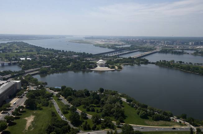 The Jefferson Memorial and Tidal Basin are seen from the 500-foot level of the Washington Monument in Washington, Monday, May 12, 2014, as it reopens. The monument, which sustained damage from an earthquake in August 2011, reopened to the public today.