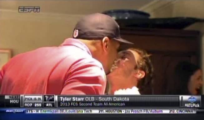 In this image taken from video, Missouri defensive end Michael Sam, left, gets a kiss at a draft party in San Diego before he was selected in the seventh round, 249th overall, by the St. Louis Rams in the NFL draft Saturday, May 10, 2014. The Southeastern Conference defensive player of the year last season came out as gay in media interviews this year.