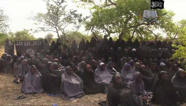 This photo taken from video by Nigeria's Boko Haram terrorist network, Monday May 12, 2014, shows the alleged missing girls abducted from the northeastern town of Chibok. The new video purports to show dozens of abducted schoolgirls, covered in jihab and praying in Arabic.