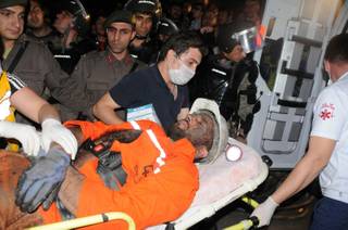 Medics place a rescued miner into an ambulance after an explosion and fire at a coal mine killed at least 17 miners and left up to 300 workers trapped underground, in Soma, in western Turkey, Tuesday, May 13, 2014, a Turkish official said.