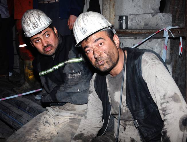 Two miners look around after being rescued hours after an explosion and fire at a coal mine killed at least 17 miners and left up to 300 workers trapped underground, in Soma, in western Turkey, late Tuesday, May 13, 2014, a Turkish official said.