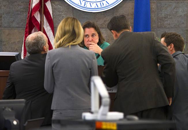 Judge Kathleen Delaney, center, confers with attorneys during a trial for Jason Omar Griffith at the Regional Justice Center Wednesday, May 14, 2014. Griffith is accused of murdering Luxor "Fantasy" dancer Deborah Flores Narvaez in December 2010.