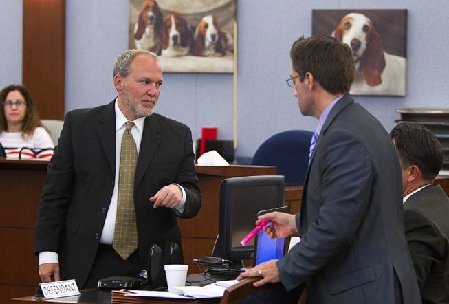 Prosecutor Marc DiGiacomo, left, helps defense attorneys with a technical problem as they prepare to play a 9-1-1 recording during a trial for Jason Omar Griffith at the Regional Justice Center Wednesday, May 14, 2014. Griffith is accused of murdering Luxor "Fantasy" dancer Deborah Flores Narvaez in December 2010.