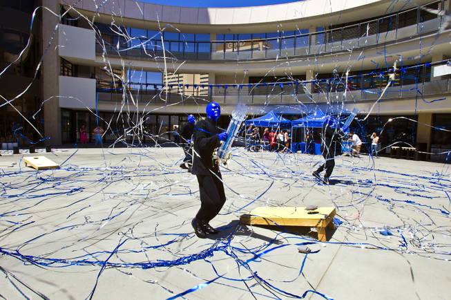 The Blue Man Group blast confetti as they celebrate the 10th Annual Zappos Bald and Blue charity event and unveiling of a collaborative, interactive art installation entitled ShoeZaphone on Wednesday, May 15, 2014.