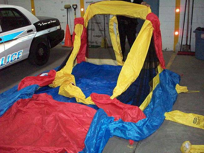 This May 13, 2014, photo provided by the South Glens Fall Police Department, shows a deflated bounce house that three children were playing in on Monday when it broke loose from plastic anchoring stakes and was swept skyward by gusty winds, in South Glens Fall, N.Y. 