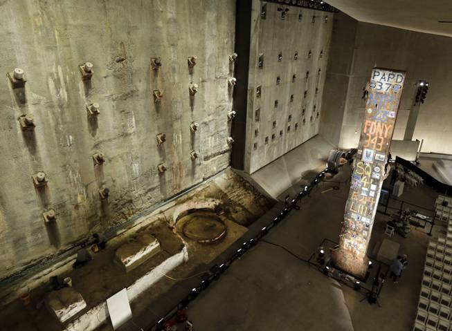 A portion of the World Trade Center slurry wall, left, and the symbolic last beam, are displayed at the National Sept. 11 Memorial Museum, Wednesday, May 14, 2014, in New York. The museum is a monument to how the Sept. 11 terror attacks shaped history, from its heart-wrenching artifacts to the underground space that houses them amid the remnants of the fallen twin towers' foundations. It also reflects the complexity of crafting a public understanding of the terrorist attacks and reconceiving ground zero.  (AP Photo)