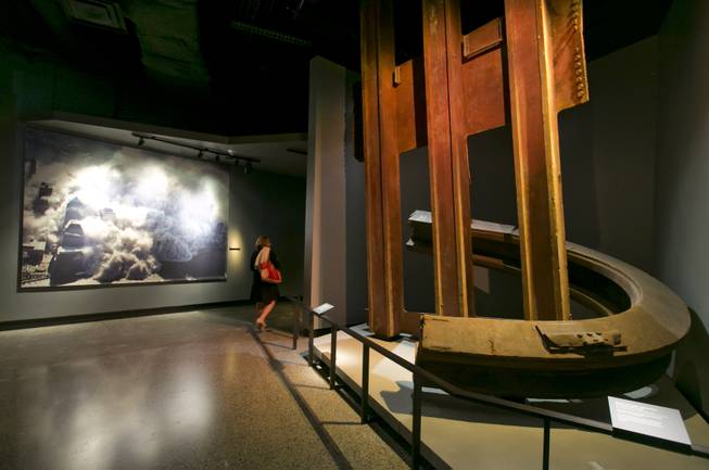 A two-inch thick World Trade Center steel column, that was bent into a horseshoe shape, and facade segment, are displayed at the National Sept. 11 Memorial Museum, Wednesday, May 14, 2014, in New York. The museum is a monument to how the Sept. 11 terror attacks shaped history, from its heart-wrenching artifacts to the underground space that houses them amid the remnants of the fallen twin towers' foundations. It also reflects the complexity of crafting a public understanding of the terrorist attacks and reconceiving ground zero.  (AP Photo)