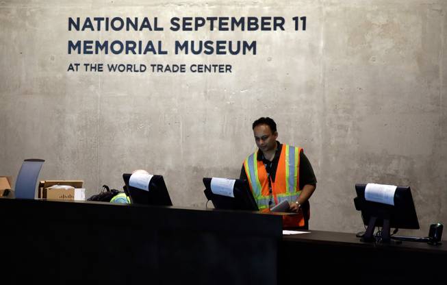 A technician readies computers at the National Sept. 11 Memorial Museum, Wednesday, May 14, 2014, in New York. The museum is a monument to how the Sept. 11 terror attacks shaped history, from its heart-wrenching artifacts to the underground space that houses them amid the remnants of the fallen twin towers' foundations. It also reflects the complexity of crafting a public understanding of the terrorist attacks and reconceiving ground zero.  (AP Photo)