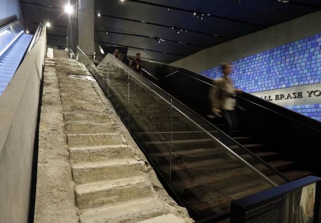 The "Survivor Stairs," left, from The World Trader Center, are displayed at the National Sept. 11 Memorial Museum, Wednesday, May 14, 2014, in New York. The museum is a monument to how the Sept. 11 terror attacks shaped history, from its heart-wrenching artifacts to the underground space that houses them amid the remnants of the fallen twin towers' foundations. It also reflects the complexity of crafting a public understanding of the terrorist attacks and reconceiving ground zero.  (AP Photo)