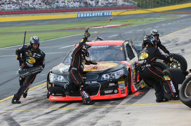 Crew members perform a pit stop on driver Jamie McMurray's car during qualifying for the NASCAR Sprint All-Star race at Charlotte Motor Speedway in Concord, N.C., on Saturday, May 17, 2014.