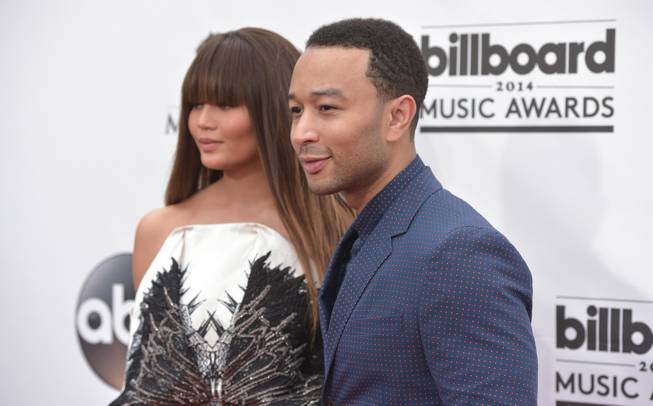Chrissy Teigen and John Legend arrive at the 2014 Billboard Music Awards at MGM Grand Garden Arena on Sunday, May 18, 2014, in Las Vegas.