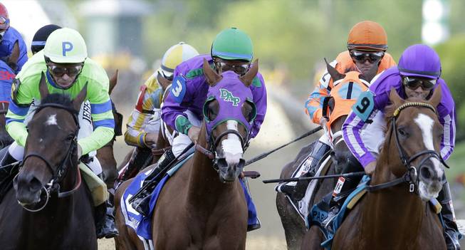 In this Saturday, May 17, 2014, photo, California Chrome, center, ridden by Victor Espinoza; Pablo Del Monte, right, ridden by Jeffrey Sanchez; and Ria Antonia, left, ridden by Calvin Borel race to the first turn during the 139th Preakness Stakes at Pimlico Race Course in Baltimore. California Chrome might abandon his Triple Crown bid if New York officials do not allow the colt to wear a nasal strip in the Belmont Stakes.