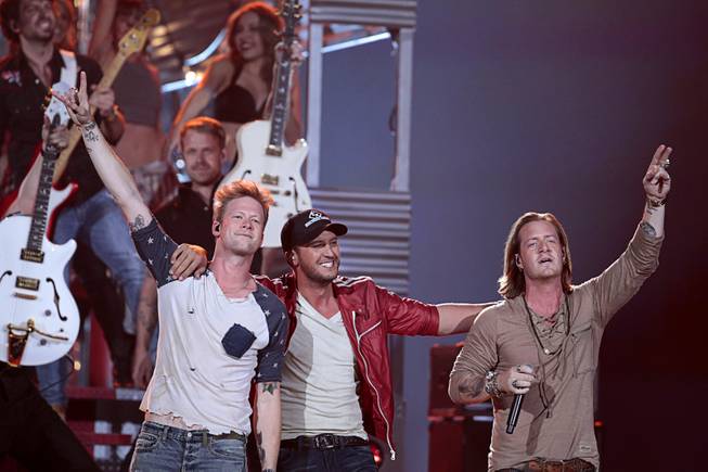 Recording artist Luke Bryan, center, and Florida Georgia Line members Brian Kelley, left, and Tyler Hubbard perform during the 2014 Billboard Music Awards at the MGM Grand Garden Arena Sunday, May 18, 2014.