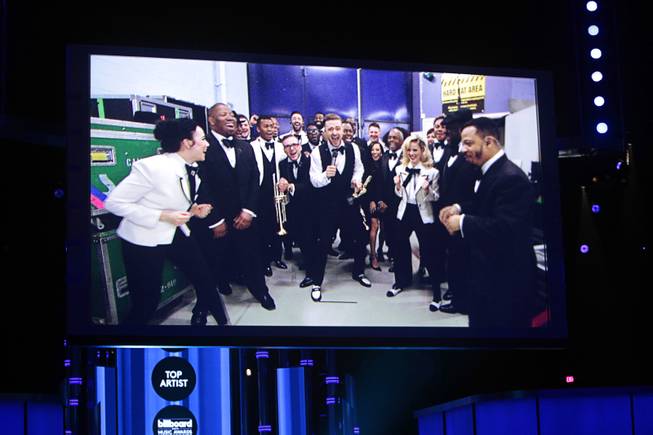 Justin Timberlake, center, accepts the award for Top Artist via satellite during the 2014 Billboard Music Awards at the MGM Grand Garden Arena Sunday, May 18, 2014.