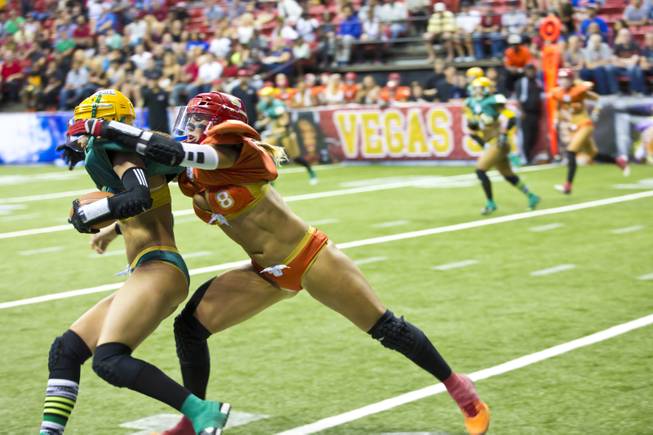 Danika Brace, of the Las Vegas SIN, grabs Jessica Peyton, of Green Bay Chill, from behind during their game at Thomas & Mack Center, Thursday May 15, 2014. The SIN beat Green Bay 34 to 24, their first win of the Legends Football League season.