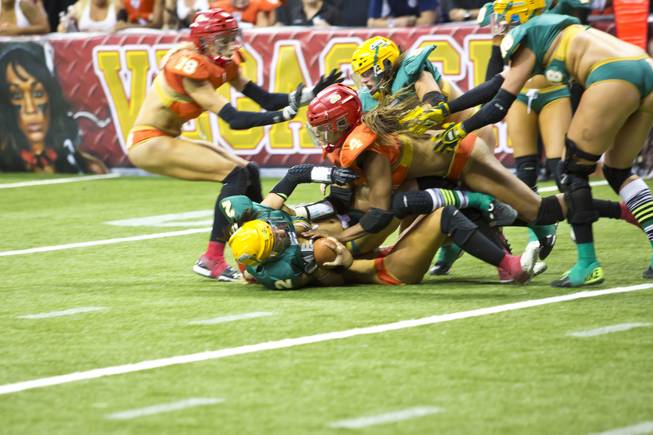 Green Bay Chill clashes with Las Vegas SIN, orange, during their game at Thomas & Mack Center, Thursday May 15, 2014. The SIN beat Green Bay 34 to 24, their first win of the Legends Football League season.