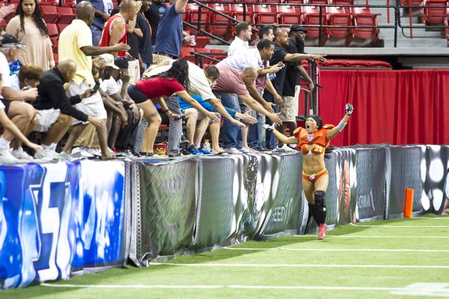 Tricia Warashina, of the Las Vegas SIN, celebrates with the crowd after defeating Green Bay Chill, Thursday May 15, 2014. The SIN beat Green Bay 34 to 24 at Thomas & Mack Center, their first win of the Legends Football League season.